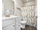 Charming bathroom features white vanity, decorative shower curtain, modern toilet, and tile flooring at 1941 La Playa Dr., Myrtle Beach, SC 29588