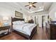 Bright bedroom featuring a tray ceiling, dark wood furniture, and plush bedding at 1941 La Playa Dr., Myrtle Beach, SC 29588