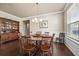 Formal dining room with dark wood floors, a round table with chairs, and a classic hutch adds sophistication at 1941 La Playa Dr., Myrtle Beach, SC 29588