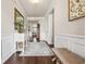 Elegant entryway with beautiful hardwood floors, wainscoting, decorative mirror, and a view into the home's layout at 1941 La Playa Dr., Myrtle Beach, SC 29588