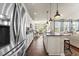 Bright kitchen with stainless steel appliances and an island with bar seating, offering a seamless living experience at 1941 La Playa Dr., Myrtle Beach, SC 29588