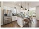 Well-lit kitchen with stainless steel appliances, granite countertops, and an island with stool seating at 1941 La Playa Dr., Myrtle Beach, SC 29588