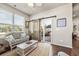 Cozy living room features a wicker sofa, sliding barn door, and access to the outdoor patio at 1941 La Playa Dr., Myrtle Beach, SC 29588