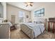 Cozy bedroom with a tufted headboard, blue accents, and ample natural light creates a relaxing atmosphere at 1941 La Playa Dr., Myrtle Beach, SC 29588