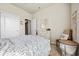 Comfortable bedroom features neutral walls, a patterned duvet, and simple decor, creating a serene space at 1941 La Playa Dr., Myrtle Beach, SC 29588