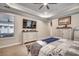 Spacious primary bedroom featuring a tray ceiling and a wall-mounted television at 2023 Singing Palm Loop, Little River, SC 29566