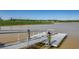 A modern metal community dock extends onto a calm pond within the neighborhood at 2023 Singing Palm Loop, Little River, SC 29566