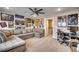 Inviting living room featuring a large sectional sofa, ceiling fan and numerous framed posters and gaming-themed artwork at 2023 Singing Palm Loop, Little River, SC 29566