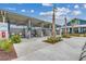 Community pool area featuring shaded cabanas and tropical landscaping at 2023 Singing Palm Loop, Little River, SC 29566