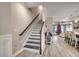 Elegant staircase with wood treads, leading to the upper level with open views of the living spaces at 2023 Singing Palm Loop, Little River, SC 29566