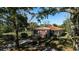 Charming brick home with copper roof, inviting front porch, and mature trees at 208 Prince St., Georgetown, SC 29440