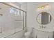 Bathroom featuring marble-tiled shower with gold trim and an ornate vanity with a decorative mirror at 212 78Th Ave. N, Myrtle Beach, SC 29572