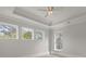 Bright bedroom with tray ceiling, fan, and multiple windows providing natural light at 212 78Th Ave. N, Myrtle Beach, SC 29572