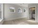 Spacious room with wood floors, arched windows, and doorway to a bathroom at 212 78Th Ave. N, Myrtle Beach, SC 29572
