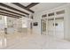 Open-concept living area features marble floors, modern lighting, and glass doors to let in plenty of natural light at 212 78Th Ave. N, Myrtle Beach, SC 29572