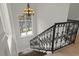 Wrought iron staircase with hardwood steps and natural light at 212 78Th Ave. N, Myrtle Beach, SC 29572