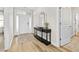 Inviting entryway with a console table, decorative mirror, neutral tones, and lots of natural light at 212 Starlit Way, Myrtle Beach, SC 29579