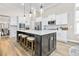 Modern kitchen features a large island with quartz countertops, seating and stylish pendant lighting at 212 Starlit Way, Myrtle Beach, SC 29579
