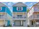 Charming raised beach home featuring a light blue exterior, white trim, and covered porch at 2308 Seaseeker Ln., Myrtle Beach, SC 29577