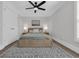 Bright bedroom with hardwood floors features a ceiling fan, a rug, and light-colored furniture at 2310 Seaseeker Ln., Myrtle Beach, SC 29577