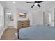 Comfortable bedroom with hardwood floors, ceiling fan and a mounted TV at 2310 Seaseeker Ln., Myrtle Beach, SC 29577