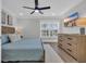 Comfortable bedroom with hardwood floors, ceiling fan, and a mounted TV at 2310 Seaseeker Ln., Myrtle Beach, SC 29577