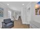 Well-lit hallway with wood look floors and multiple white paneled doors at 2310 Seaseeker Ln., Myrtle Beach, SC 29577