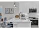 Bright kitchen with white cabinets, stainless appliances, and island with bar seating at 2310 Seaseeker Ln., Myrtle Beach, SC 29577