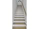 Elegant staircase with wooden handrail and contrasting risers, adding charm to the home's interior at 2310 Seaseeker Ln., Myrtle Beach, SC 29577