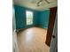 Bright bedroom featuring vibrant blue walls, wood floors, and a window at 232 Weyburn St., Myrtle Beach, SC 29579