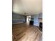 Spacious living room featuring wood floors, a brick fireplace, and ample natural light at 232 Weyburn St., Myrtle Beach, SC 29579