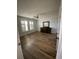 Large main bedroom showcasing wood floors, white shutters, and ceiling fan at 232 Weyburn St., Myrtle Beach, SC 29579