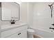 Modern bathroom features a sleek vanity, black fixtures, and a shower-tub combination at 2426 Park St., North Myrtle Beach, SC 29582