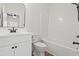 Bathroom with black fixtures, black framed mirror, and white cabinets at 2426 Park St., North Myrtle Beach, SC 29582