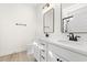 Bathroom featuring double sinks, white cabinets, black hardware, and matching mirrors at 2426 Park St., North Myrtle Beach, SC 29582