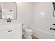Bathroom featuring a single sink with quartz countertop and matte black fixtures with a view into the shower/tub at 2426 Park St., North Myrtle Beach, SC 29582