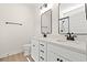 Well-lit bathroom with double sinks, white cabinets, quartz countertop, two mirrors, and matte black fixtures at 2426 Park St., North Myrtle Beach, SC 29582