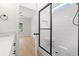 Modern bathroom featuring a glass-enclosed shower with white subway tile and a seat, plus a view into the bedroom at 2426 Park St., North Myrtle Beach, SC 29582