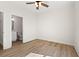 Bedroom with wood-look floors, neutral walls, ceiling fan, and a view into the bathroom at 2426 Park St., North Myrtle Beach, SC 29582