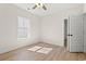 Bright bedroom with wood-look floors, neutral walls, ceiling fan, and a view into the hallway at 2426 Park St., North Myrtle Beach, SC 29582