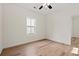 Bedroom featuring light walls, light wood-look floors, a ceiling fan, and a window at 2426 Park St., North Myrtle Beach, SC 29582