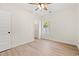 Bright bedroom featuring wood-look floors, neutral walls, a ceiling fan, and a view into the closet at 2426 Park St., North Myrtle Beach, SC 29582