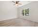 Bright bedroom with ceiling fan and large window overlooking green trees at 2426 Park St., North Myrtle Beach, SC 29582