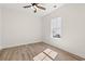 Cozy bedroom featuring wood-look floors, a ceiling fan, and a window overlooking a landscaped yard at 2426 Park St., North Myrtle Beach, SC 29582