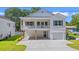 Charming two-story white home featuring a covered porch, attached garage, and well-maintained lawn at 2426 Park St., North Myrtle Beach, SC 29582