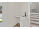 Hallway with a sink and white cabinets located under the stairs at 2426 Park St., North Myrtle Beach, SC 29582
