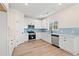 Well-equipped kitchen with stainless steel appliances, blue backsplash, and white cabinetry at 2426 Park St., North Myrtle Beach, SC 29582