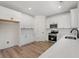 Modern kitchen featuring white cabinets, stainless steel appliances, and quartz countertops at 2426 Park St., North Myrtle Beach, SC 29582