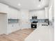Modern kitchen with white cabinets, stainless steel appliances, and a blue backsplash at 2426 Park St., North Myrtle Beach, SC 29582