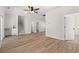Spacious living room with wood-look flooring, ceiling fan, and stairway to the second floor at 2426 Park St., North Myrtle Beach, SC 29582